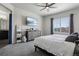 Bright primary bedroom with neutral paint, gray carpet, TV, and closet at 12233 Hannibal St, Commerce City, CO 80603