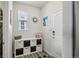 Inviting entryway with decoratively organized storage, clock, and neutral color scheme at 12233 Hannibal St, Commerce City, CO 80603