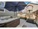 Backyard featuring a hot tub and lush landscaping, creating a private outdoor relaxation space at 12233 Hannibal St, Commerce City, CO 80603