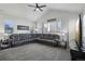 Spacious living room with vaulted ceiling, ceiling fan, and comfortable sectional sofa at 12233 Hannibal St, Commerce City, CO 80603