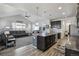 Bright and airy living room featuring vaulted ceiling, and open concept layout connecting to the modern kitchen at 12233 Hannibal St, Commerce City, CO 80603