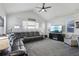 Large living room featuring a gray sectional sofa, television, and neutral-colored walls at 12233 Hannibal St, Commerce City, CO 80603