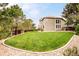Large backyard with lush green lawn and a wood fence perimeter at 1210 Snowberry Ln, Broomfield, CO 80020