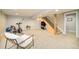 Spacious finished basement with an exercise bike and staircase at 1210 Snowberry Ln, Broomfield, CO 80020