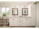 Bathroom featuring double sinks, ample storage, and great natural light at 1210 Snowberry Ln, Broomfield, CO 80020