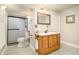Bathroom with shower, single vanity, and wood-look cabinet at 1210 Snowberry Ln, Broomfield, CO 80020