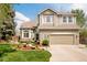 Charming two-story home with stone accents, manicured lawn, and attached two car garage at 1210 Snowberry Ln, Broomfield, CO 80020