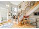 Welcoming foyer featuring a grand staircase, hardwood floors, and ample natural light at 1210 Snowberry Ln, Broomfield, CO 80020