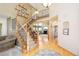 Beautiful foyer with staircase, wood floors, and view into the living room at 1210 Snowberry Ln, Broomfield, CO 80020