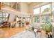 Bright living room with open floor plan, large windows, hardwood floors, and a stylish kitchen view at 1210 Snowberry Ln, Broomfield, CO 80020