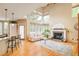 Bright living area with a fireplace, hardwood floors, and a breakfast bar area at 1210 Snowberry Ln, Broomfield, CO 80020