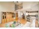 Spacious living room with hardwood floors, an open floor plan, and modern lighting at 1210 Snowberry Ln, Broomfield, CO 80020
