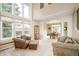 Bright living room with high ceilings, large windows, and comfortable seating arrangement at 1210 Snowberry Ln, Broomfield, CO 80020
