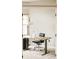 Bright home office with a modern desk, ergonomic chair, and large window at 1210 Snowberry Ln, Broomfield, CO 80020