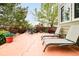 Beautiful patio with lounge chairs, outdoor dining table, and lush greenery at 1210 Snowberry Ln, Broomfield, CO 80020