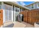 Backyard featuring a wood fence, a concrete patio, a grill, a flower pot, and a view of the home at 9901 E Evans Ave # 9A, Aurora, CO 80247