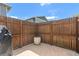 Backyard featuring a wood fence, a concrete patio, a grill, a flower pot, and a view of the home at 9901 E Evans Ave # 9A, Aurora, CO 80247