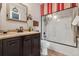 Bathroom featuring dark cabinets, granite countertop, toilet, and shower with red accents at 9901 E Evans Ave # 9A, Aurora, CO 80247