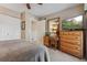 Bedroom featuring a closet, wooden desk, large television, a ceiling fan, and neutral toned walls at 9901 E Evans Ave # 9A, Aurora, CO 80247