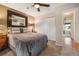 Bedroom featuring a large bed, framed mirror, closet with folding doors, and a ceiling fan at 9901 E Evans Ave # 9A, Aurora, CO 80247