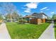 Exterior view of a single-story home featuring a well-maintained lawn with sidewalk at 9901 E Evans Ave # 9A, Aurora, CO 80247