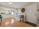 Bright kitchen featuring white cabinets, a dining table, and laminate floors at 9901 E Evans Ave # 9A, Aurora, CO 80247