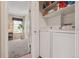 Laundry room featuring a washer and dryer, shelving, a light fixture, and a view to the rest of the home at 9901 E Evans Ave # 9A, Aurora, CO 80247