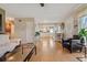 Spacious living area open to the kitchen, featuring wood flooring and white trim at 9901 E Evans Ave # 9A, Aurora, CO 80247