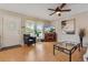 Bright living room with wood floors, featuring a large window and media center at 9901 E Evans Ave # 9A, Aurora, CO 80247