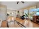 Open-concept living area with laminate floors, a ceiling fan, and seamless access to the kitchen at 9901 E Evans Ave # 9A, Aurora, CO 80247