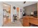 Office with a view into the bathroom and living room and featuring wood furniture and neutral walls at 9901 E Evans Ave # 9A, Aurora, CO 80247