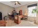 Home office featuring wood furniture, a large window for light, a ceiling fan, and neutral walls at 9901 E Evans Ave # 9A, Aurora, CO 80247