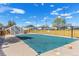 Community pool with a safety cover surrounded by a wooden fence, providing recreation and peace of mind at 9901 E Evans Ave # 9A, Aurora, CO 80247