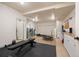 Basement area with workout equipment, two sets of washer/dryers, and ample open space at 21016 Horse Bit Way, Morrison, CO 80465