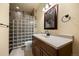 Nicely tiled bathroom featuring a glass block shower, modern vanity and ample lighting fixtures at 21016 Horse Bit Way, Morrison, CO 80465