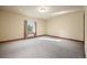 Bright, empty bedroom with neutral carpet, fresh paint, and a large window at 21016 Horse Bit Way, Morrison, CO 80465