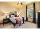 Cozy bedroom featuring a stylish bed, unique artwork, and ample natural light from the window at 21016 Horse Bit Way, Morrison, CO 80465