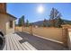 Secluded backyard deck featuring stone pillar accents and scenic mountain views at 21016 Horse Bit Way, Morrison, CO 80465