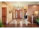 Grand entryway with wood flooring, unique light fixture, and wooden front door at 21016 Horse Bit Way, Morrison, CO 80465