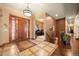 Grand entryway with wood flooring, unique light fixture, and wood front door at 21016 Horse Bit Way, Morrison, CO 80465