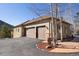 Spacious home with a three-car garage, stone accents, and a well-maintained driveway at 21016 Horse Bit Way, Morrison, CO 80465