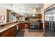 Open concept kitchen with stainless steel appliances, granite countertops, and gas range at 21016 Horse Bit Way, Morrison, CO 80465