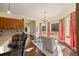 Open living area with bar seating, a small table and chairs with views, and hardwood floors at 21016 Horse Bit Way, Morrison, CO 80465