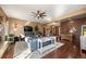 Open living room with area rug, ceiling fan, modern furniture and hardwood flooring at 21016 Horse Bit Way, Morrison, CO 80465