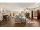 Expansive living space featuring hardwood floors, a stone fireplace, large windows, and comfortable furnishings at 21016 Horse Bit Way, Morrison, CO 80465