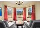 Bright sitting area with scenic views, elegant window treatments, and hardwood floors at 21016 Horse Bit Way, Morrison, CO 80465