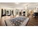 Spacious living area with hardwood floors, large windows, fireplace, and access to the outdoor patio at 21016 Horse Bit Way, Morrison, CO 80465