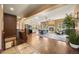 Open-concept living area with fireplace, modern furniture, and hardwood floors at 21016 Horse Bit Way, Morrison, CO 80465