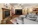 Inviting living room with stone fireplace, built-in shelving, recessed lighting, and comfortable seating at 21016 Horse Bit Way, Morrison, CO 80465