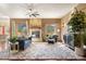 Spacious living room featuring stone fireplace, large windows, and comfortable seating at 21016 Horse Bit Way, Morrison, CO 80465